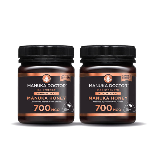 Two jars of Manuka Doctor Max Strength Monofloral Manuka Honey 700 MGO with black lids, shown side-by-side on a white background.